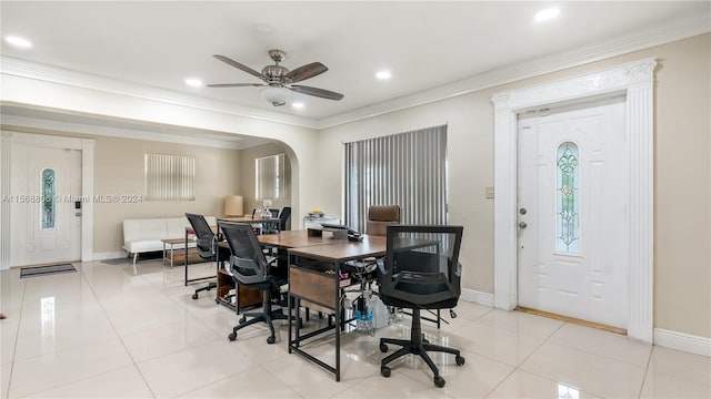 tiled dining room with ceiling fan and ornamental molding