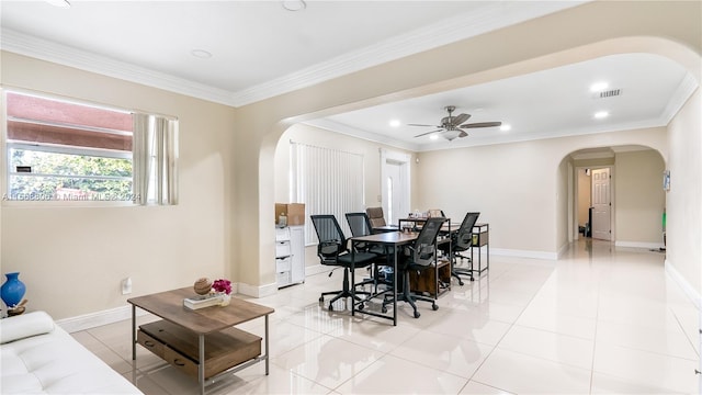 tiled dining space with ceiling fan and ornamental molding