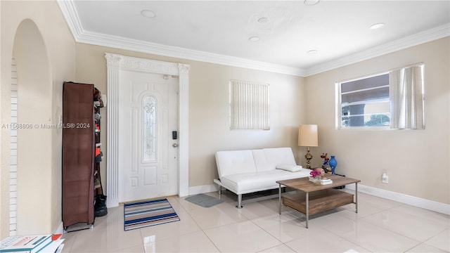 entrance foyer with crown molding and light tile floors