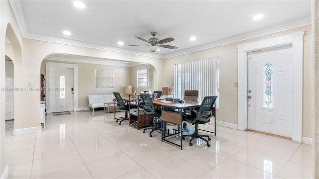 tiled dining area featuring ceiling fan, crown molding, and a wealth of natural light