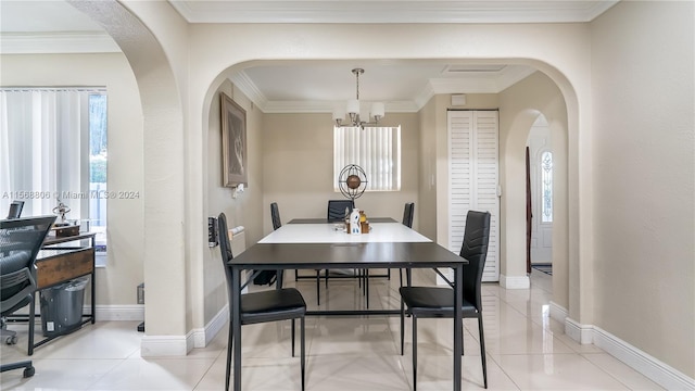 tiled dining area featuring ornamental molding and an inviting chandelier