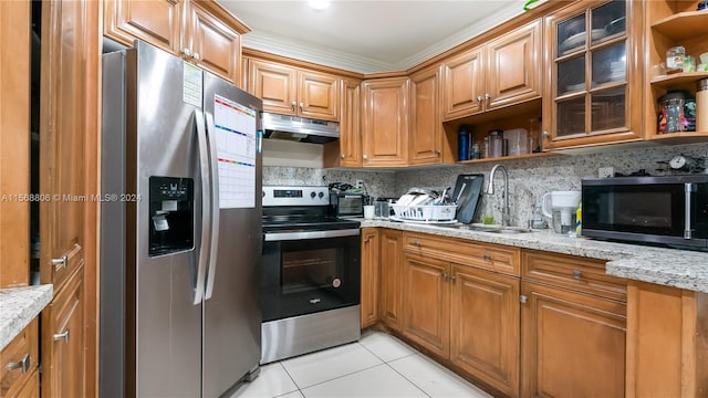 kitchen with light stone counters, sink, backsplash, light tile flooring, and stainless steel appliances