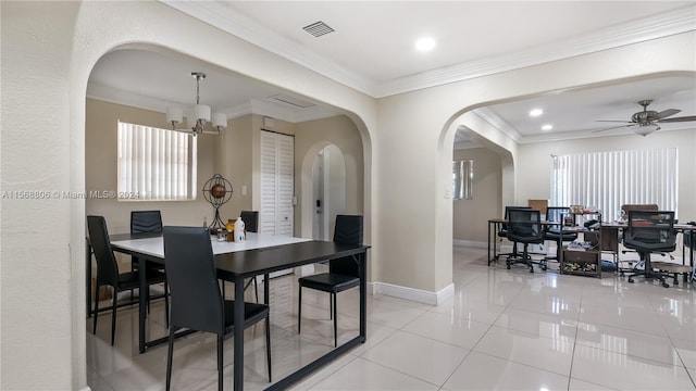 dining space with crown molding, light tile floors, and ceiling fan with notable chandelier