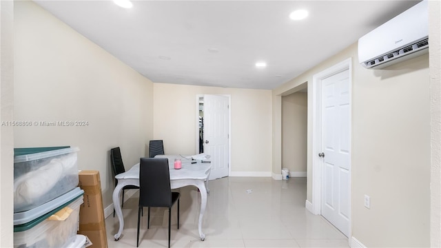 office area with an AC wall unit and light tile floors