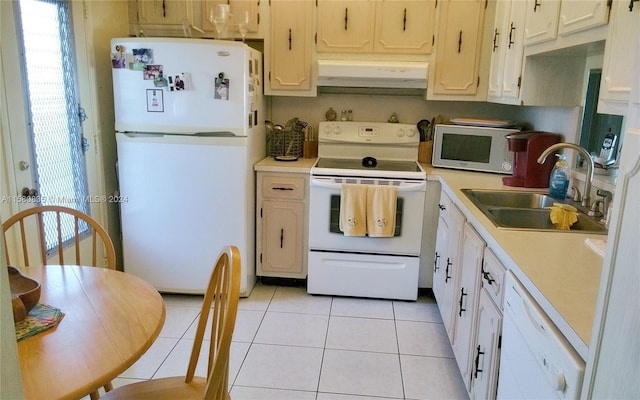 kitchen featuring sink, white appliances, and light tile patterned floors