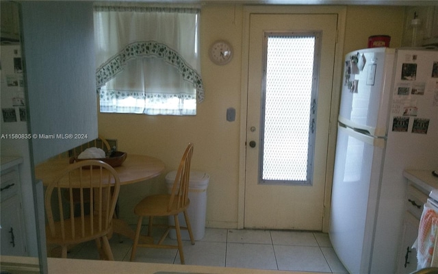 dining space featuring light tile patterned floors