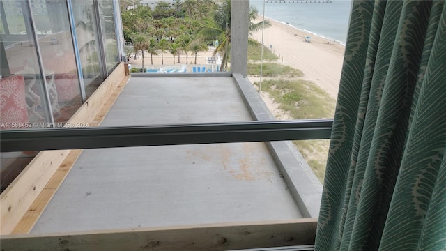 interior space featuring a view of the beach and a water view