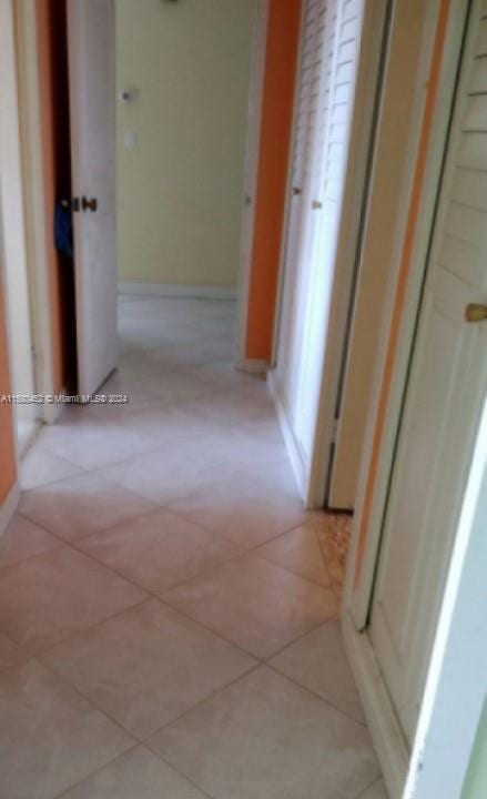 corridor with light tile patterned floors