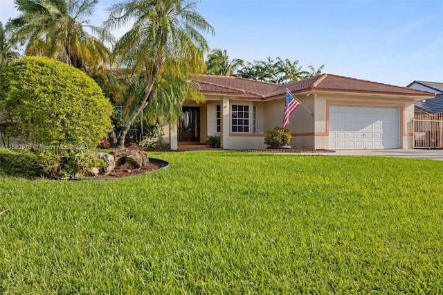 view of front of property with a front yard and a garage