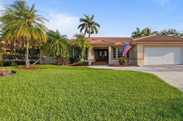 view of front of home with a garage and a front yard