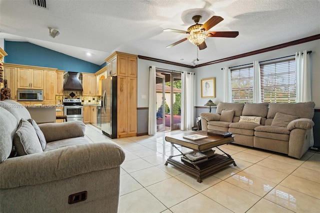 living room featuring lofted ceiling, ceiling fan, light tile patterned floors, and a textured ceiling