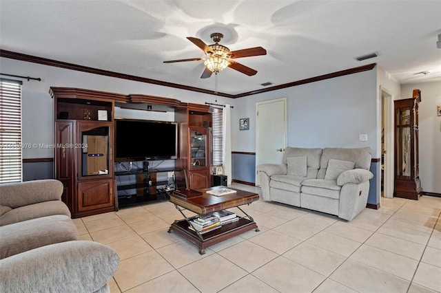 living room featuring light tile patterned flooring, ceiling fan, a textured ceiling, and ornamental molding