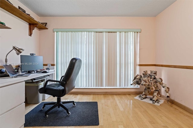 office featuring a textured ceiling and light wood-type flooring