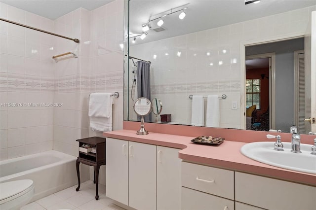 full bathroom featuring tile patterned flooring, vanity, toilet, and shower / tub combo