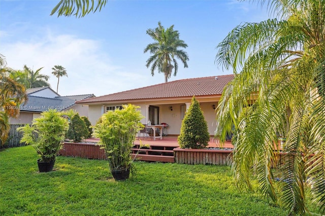 rear view of house with a yard and a deck