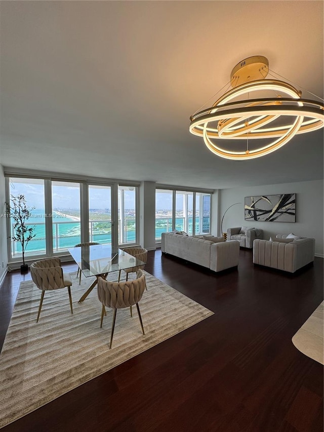 dining area with dark hardwood / wood-style flooring and a wall of windows