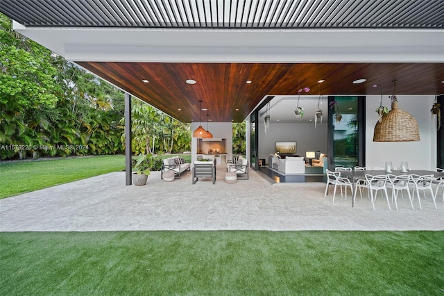 view of patio with an outdoor living space with a fireplace