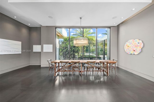 dining room featuring baseboards, floor to ceiling windows, concrete floors, and recessed lighting