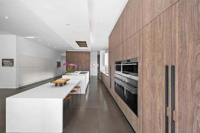 kitchen with oven, stainless steel oven, and a spacious island