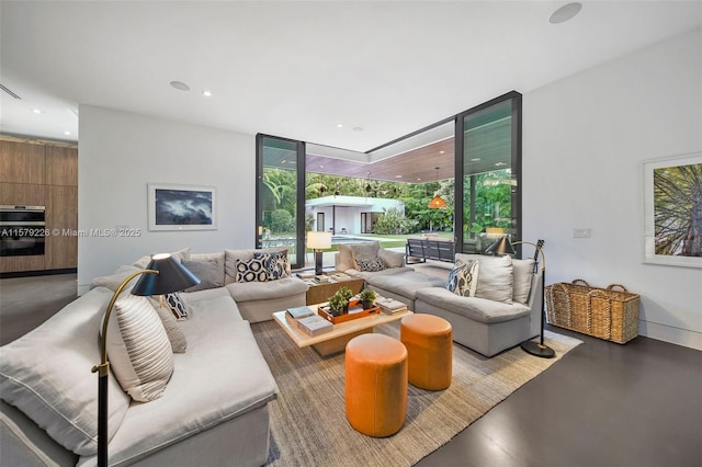 living area featuring concrete floors, expansive windows, and recessed lighting