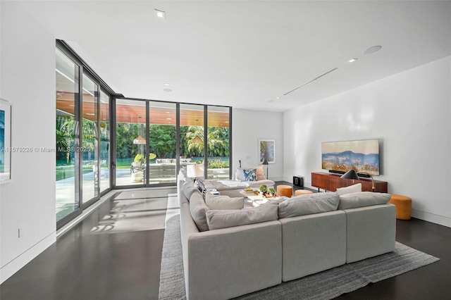 living area with baseboards and floor to ceiling windows