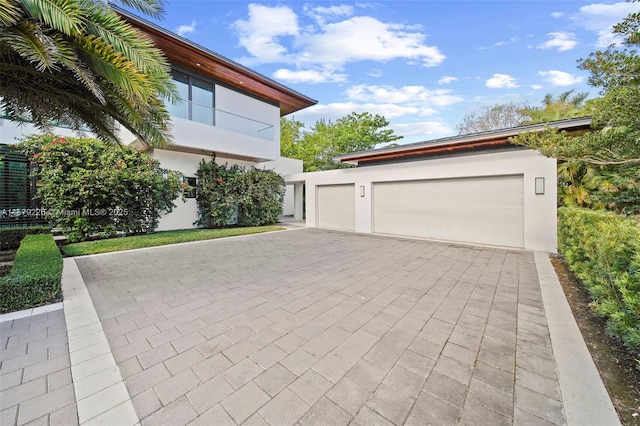 exterior space featuring driveway and stucco siding