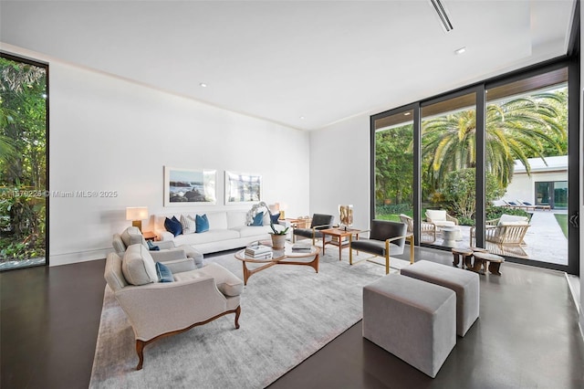 living area with floor to ceiling windows and concrete flooring
