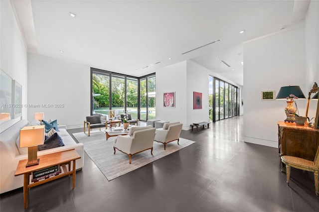 interior space with baseboards, a high ceiling, a healthy amount of sunlight, and floor to ceiling windows