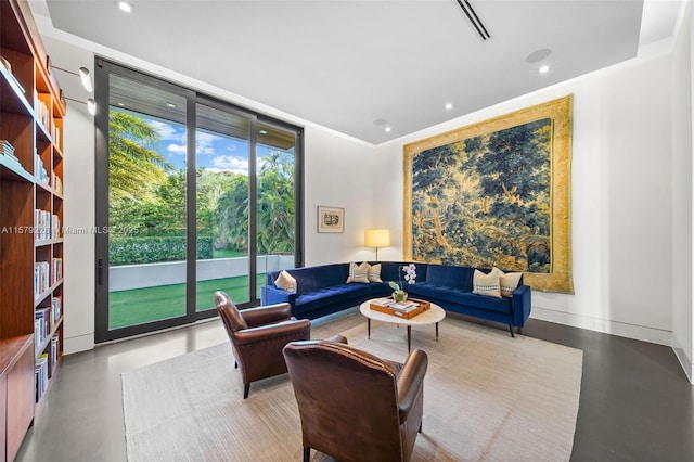 living area with finished concrete floors, visible vents, and recessed lighting