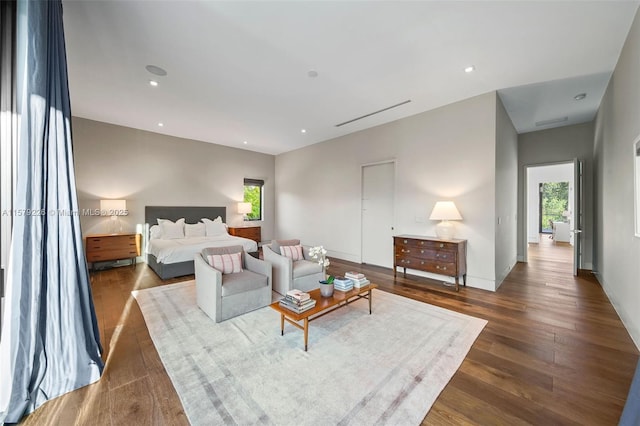 bedroom with dark wood-style floors and recessed lighting
