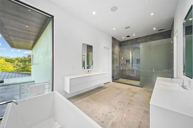 bathroom featuring vanity and shower with separate bathtub