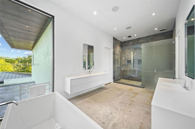full bath with recessed lighting, visible vents, vanity, a freestanding tub, and a stall shower