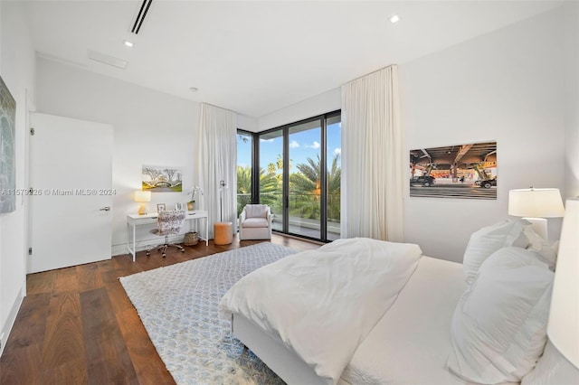 bedroom featuring access to exterior and dark wood-type flooring