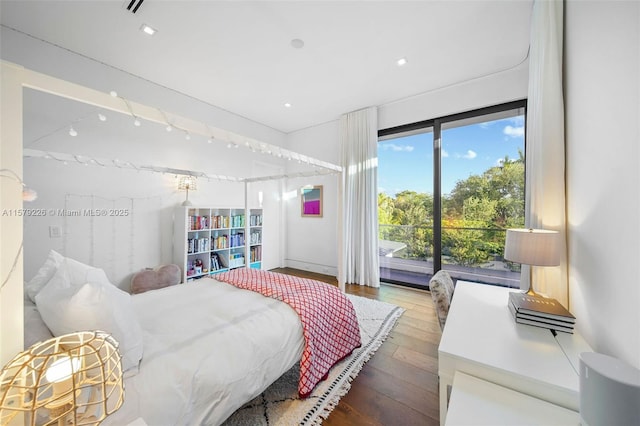 bedroom with wood-type flooring and access to outside