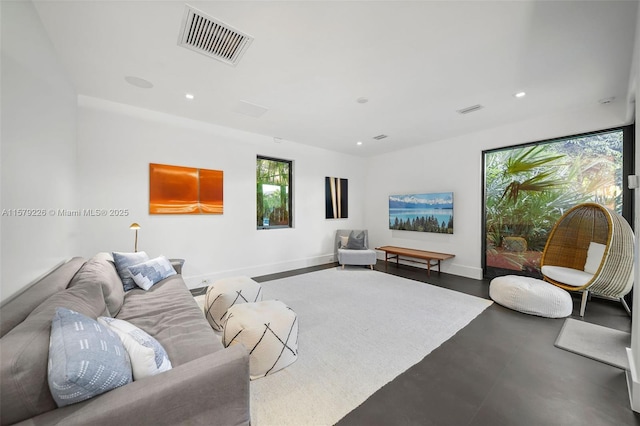 living room featuring recessed lighting, concrete floors, visible vents, and baseboards