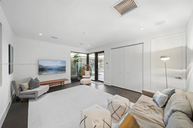 living area featuring baseboards, visible vents, and recessed lighting