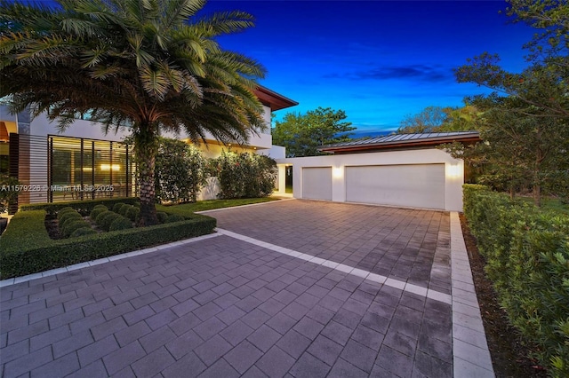view of front of house featuring stucco siding and decorative driveway