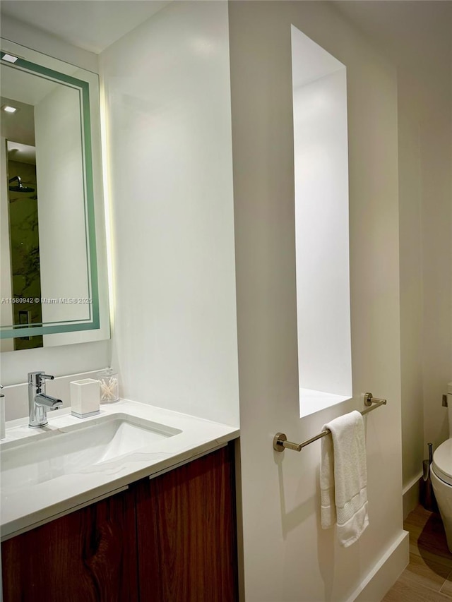 bathroom featuring hardwood / wood-style floors, toilet, and vanity