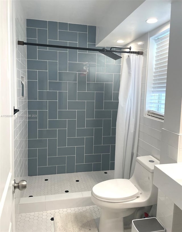 bathroom featuring tile flooring, tile walls, toilet, and a shower with shower curtain