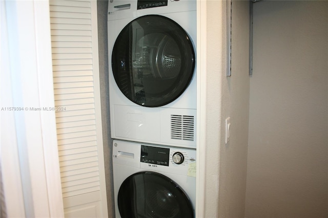 laundry room with stacked washer / dryer