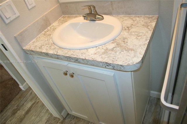 bathroom with hardwood / wood-style floors and vanity