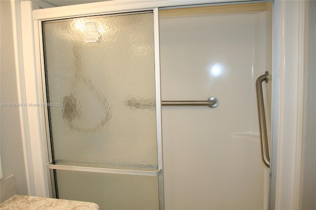 bathroom featuring walk in shower and vanity