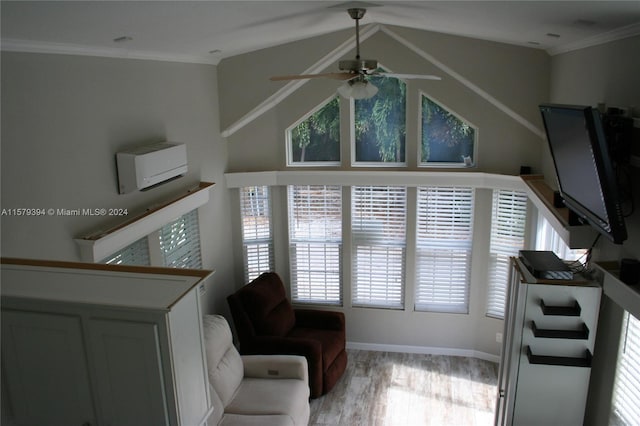 living area featuring ceiling fan, an AC wall unit, vaulted ceiling, crown molding, and light hardwood / wood-style flooring