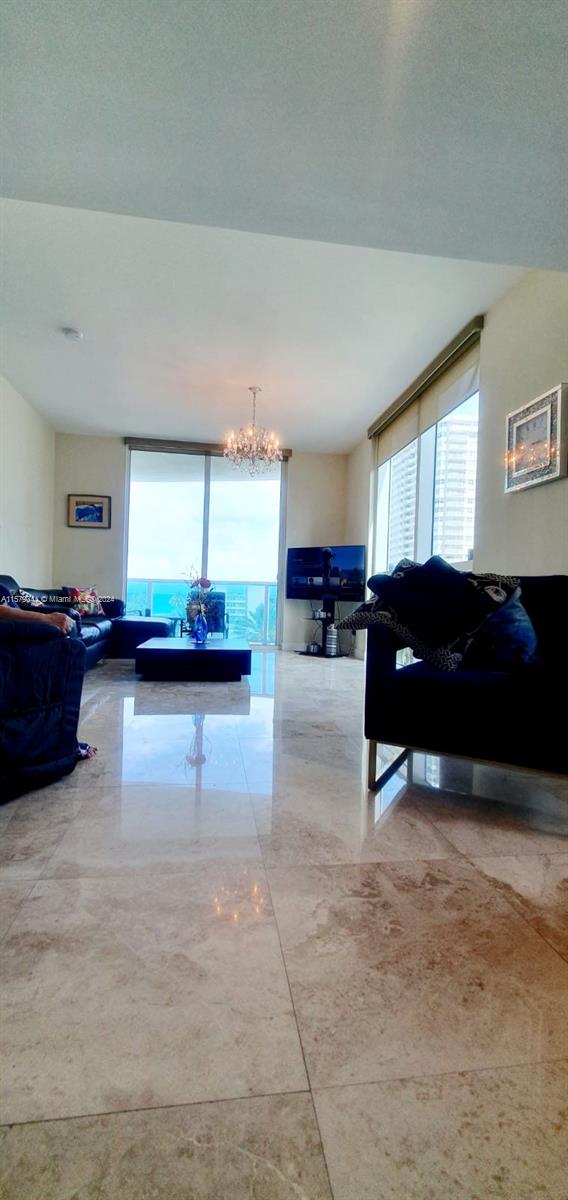 living room featuring a chandelier and a textured ceiling