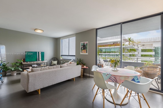 tiled living room featuring a wall of windows