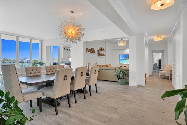 dining space with ornamental molding, floor to ceiling windows, light wood-type flooring, and an inviting chandelier