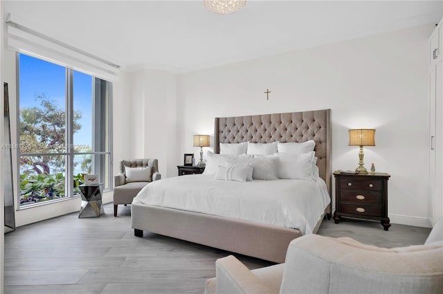 bedroom with hardwood / wood-style floors and crown molding