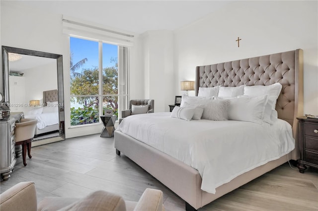 bedroom featuring light hardwood / wood-style flooring and multiple windows