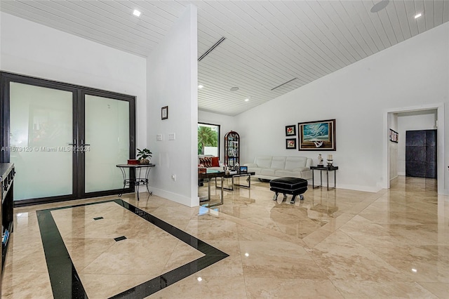 foyer entrance featuring high vaulted ceiling and wood ceiling