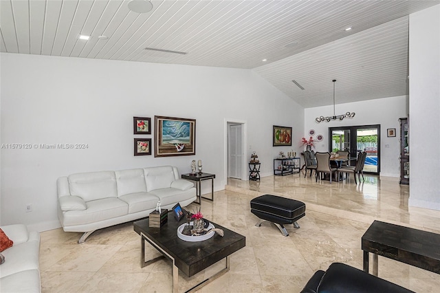 living room with wooden ceiling, high vaulted ceiling, and french doors